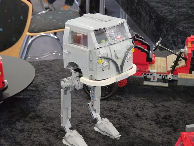 A LEGO VW T1 camper van standing on the legs of an AT-AT walker
